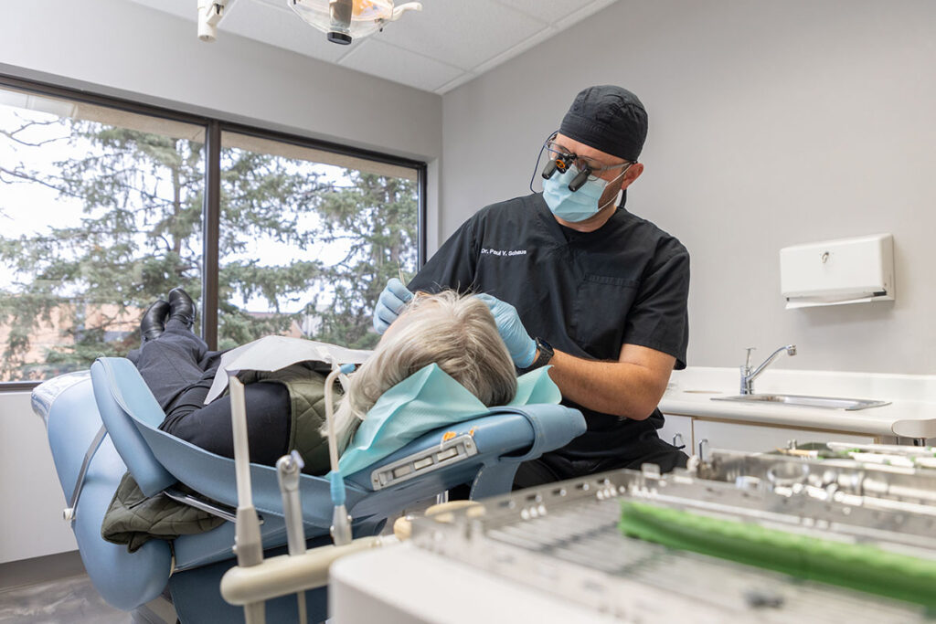 Dr. Paul Schaus with a patient performing a dental exam