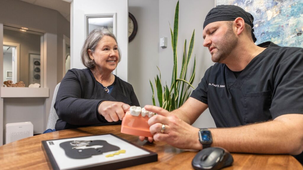 people talking with a tooth mold